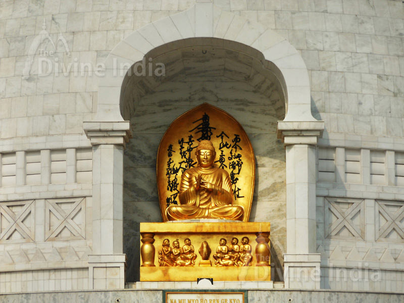The first of the four Buddhas, presiding at the entrance of the Vishwa Shanti Stupa.