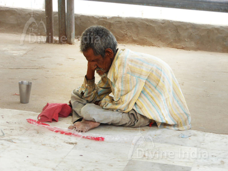 Old Man is Begging outside the Jain Temple.