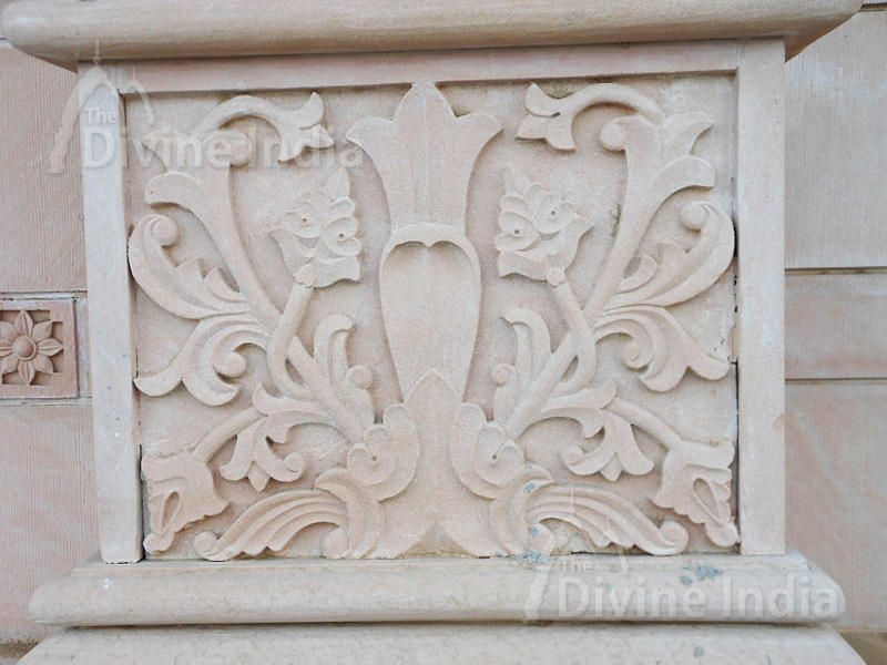 Wall sculpture from a stone in the form of a flower on walls