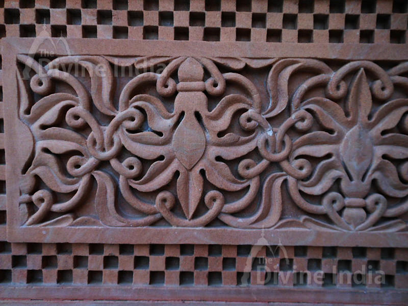 Wall sculpture from a stone in the form of a flower on walls