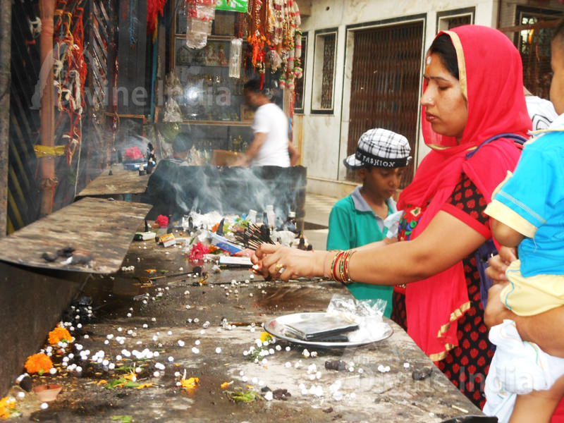 Devotee offering prayer at neelkanth mahadev temple