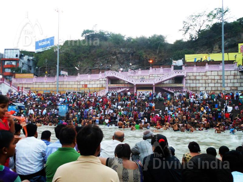 People sitting on the steps of the ghat waiting for the Ganga Arati