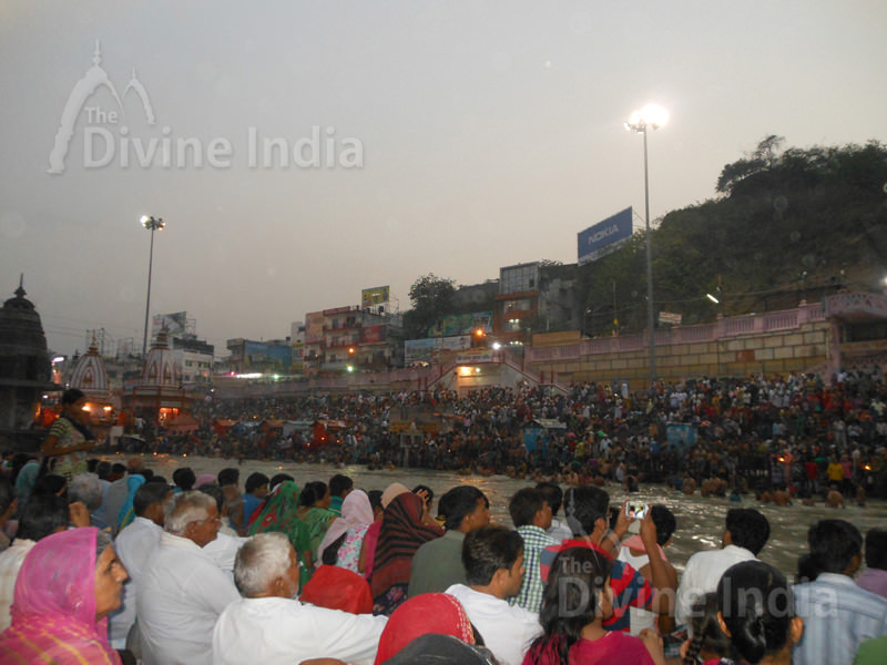 People sitting on the steps of the ghat waiting for the Ganga Arati
