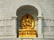 The first of the four Buddhas, presiding at the entrance of the Vishwa Shanti Stupa.
