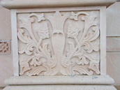 Wall sculpture from a stone in the form of a flower on walls