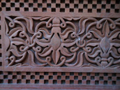 Wall sculpture from a stone in the form of a flower on walls