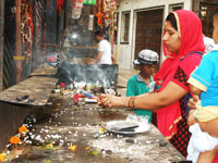 Devotee offering prayer at neelkanth mahadev temple